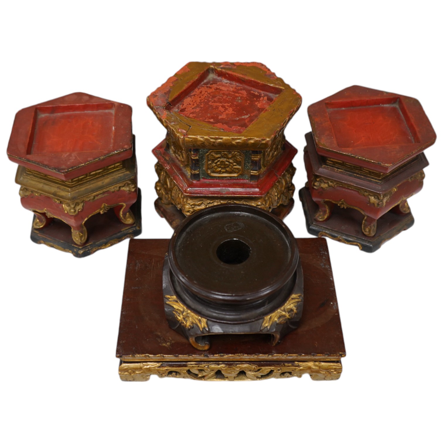 Five Chinese lacquered and partially gilt stands including a hexagonal pair, largest 15cm high. Condition - mostly fair